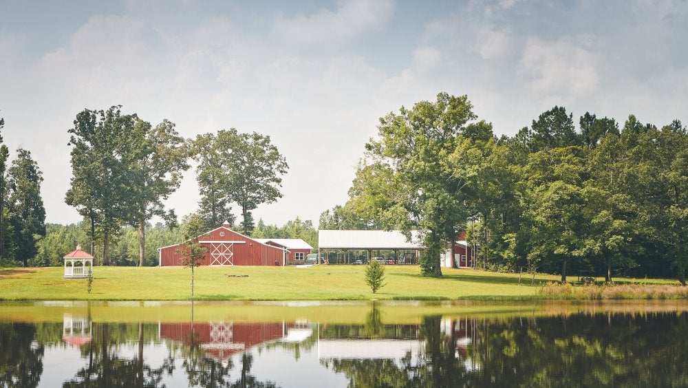 Piece of land with a red barn on it 