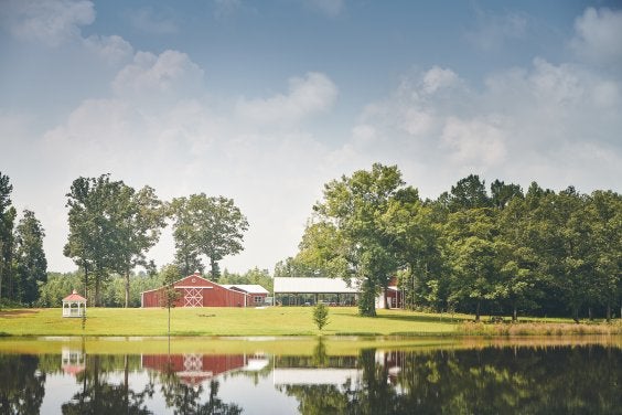 Piece of land with a red barn on it 