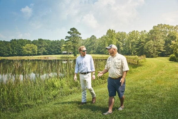 guys walking and talking around lake